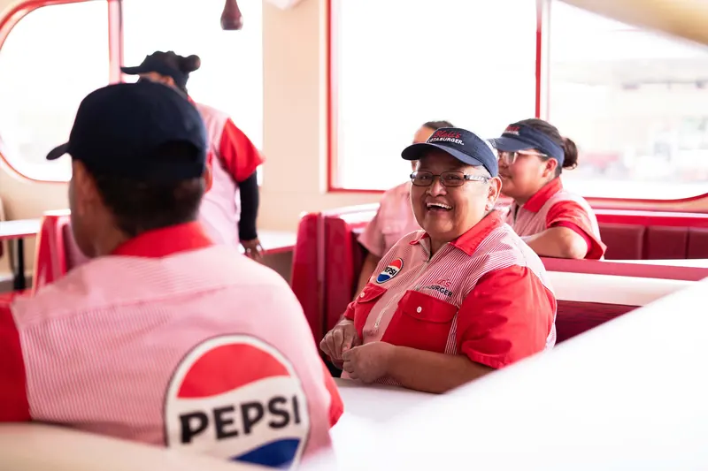 Blake’s Lotaburger: Pepsi on the back, the crew in a booth