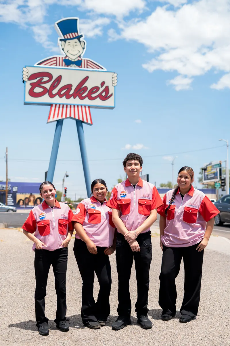 Blake’s Lotaburger: Four of the crew under the Blake’s sign